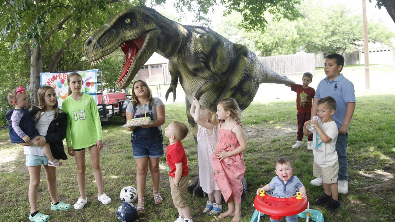 Pictured is Norman the dinosaur entertaining a group of kids at a birthday party. (Credit: Krysti Burton)